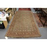An unusual Persian rug, rust ground with large stylized boteh decoration.