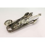 Silver sugar tongs and spoons.