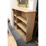 A stained pine shelf unit.