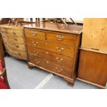 A George III mahogany straight front chest of two short and three graduated long drawers on ogee