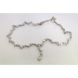 A decorative silver necklace.