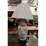 A Chinese floral decorated porcelain table lamp.