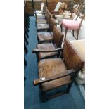 A set of six oak framed and leather upholstered dining chairs, two with arms.