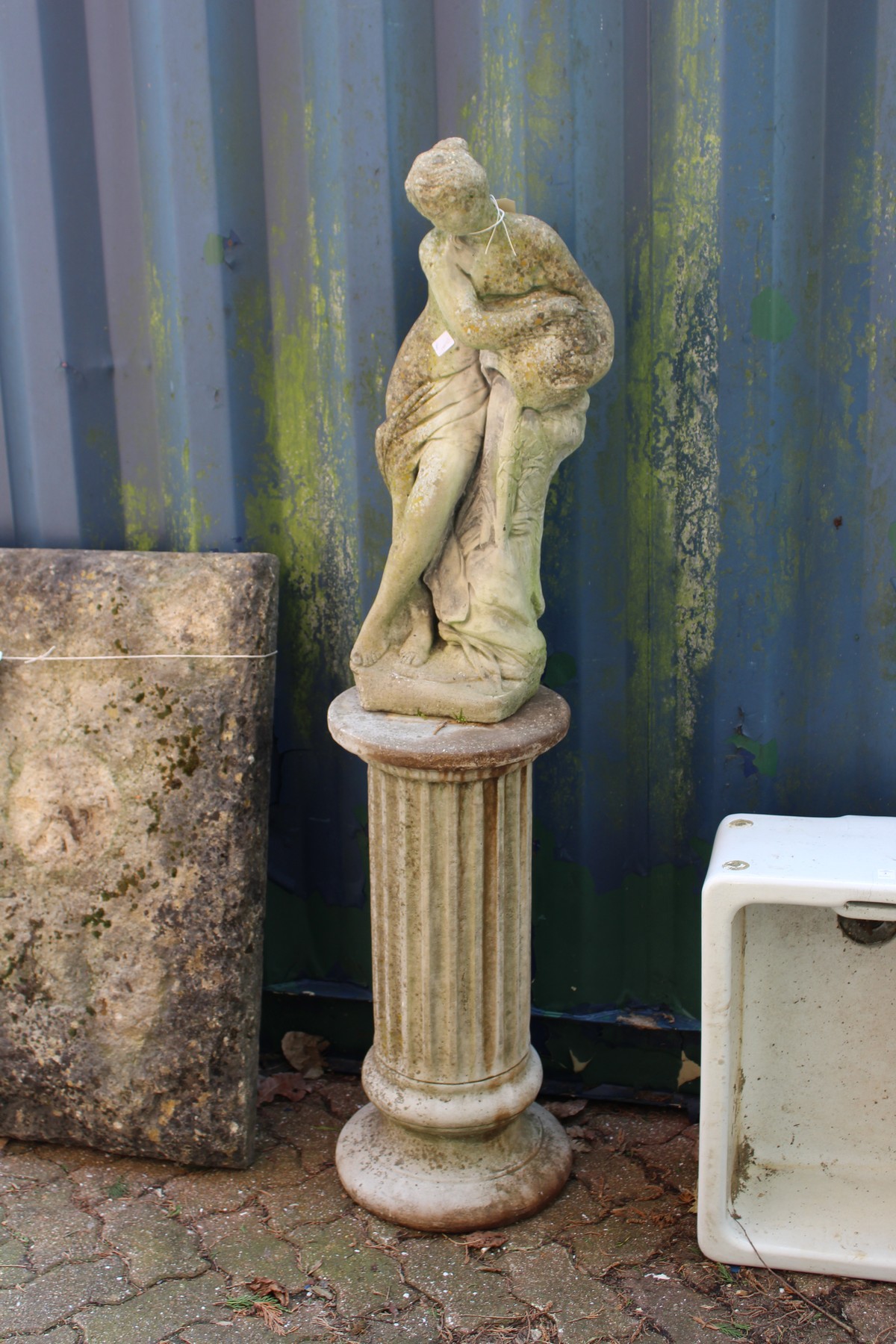 A composite garden classical figure on pedestal base.