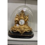 A French gilt spelter mantle clock under an associated glass dome.