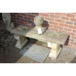 A weathered composite stone classical style bench.