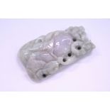 A carved jade amulet.