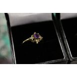 A 9ct gold and diamond and amethyst ring.