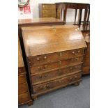 A George III oak bureau (faults).