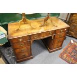 A walnut pedestal desk.