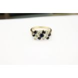 A 9ct gold, diamond and sapphire ring.