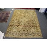 A Persian rug, light beige ground with floral decoration.