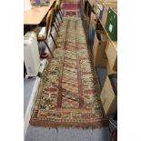 A Persian runner, beige ground with three rows of geometric design.