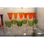 A set of six Val St Lambert wine glasses and a set of six orange wine glasses.