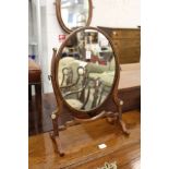 An oval dressing table mirror.