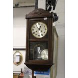 An oak cased drop dial wall clock.