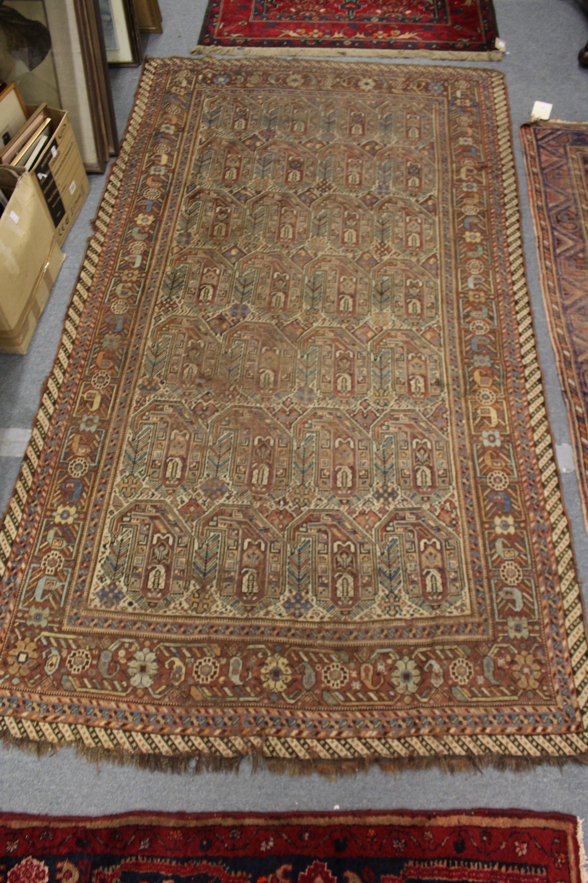 An unusual Persian rug, rust ground with large stylized boteh decoration. - Image 2 of 2