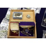 A 9ct RAF brooch, various other brooches and a pair of cufflinks.