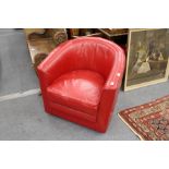 A red leather cloth upholstered tub armchair.