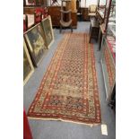 A Persian runner / hall carpet (worn).