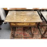 A 18th century oak side table with drawer on turned supports.