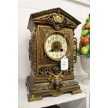 A decorative 19th century cast brass mantle clock.