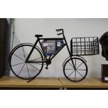 A wrought iron model of an advertising bicycle.