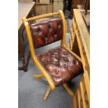 A leather upholstered office swivel desk chair.