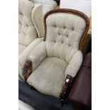 A Victorian button upholstered mahogany framed armchair.