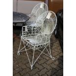 A good pair of painted wrought iron wirework armchairs.