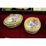 Two enamel boxes with ormolu mounted hinged covers, decorated with flowers.