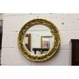 A gilt framed circular mirror.