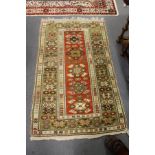 A modern Persian design rug, central red ground with stylized decoration within a similar green