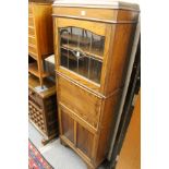 A 1940's oak narrow secretaire cupboard bookcase.