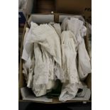 A quantity of christening gowns.