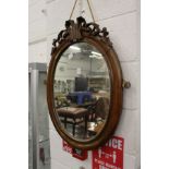 A mahogany framed oval wall mirror.