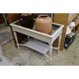 A white painted, zinc lined jardiniere / plant trough.