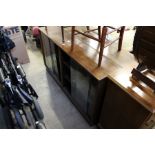 Two oak oak bookcases with glass sliding doors.