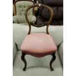 A Victorian walnut balloon back dining chair.