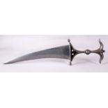 A FINE INDIAN POLISHED STEEL DAGGER, the handle with bow shaped pommel, disc shaped hand guard and