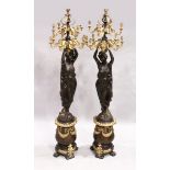 A VERY GOOD PAIR OF CLASSICAL GILDED AND BRONZE STANDING CANDELABRA standing as two classical