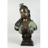 A GILDED BRONZE BUST OF AN ARAB LADY with plumed head dress and bead decoration, 2 ft. 5 in. high.