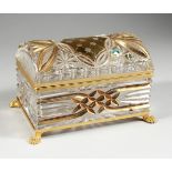 A CUT GLASS AND GILDED CASKET with domed top on clawed feet, 7 in. wide.