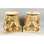 A GOOD PAIR OF CREAM AND GILDED STANDS with circular tops and scrolling acanthus, 1 ft. 4 in. high.