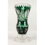 A LARGE BOHEMIAN GREEN CUT GLASS VASE on a plain circular base. 18.5ins high.