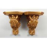 A GOOD PAIR OF GILDED WALL BRACKETS with scrolling decoration, 20 in. high.