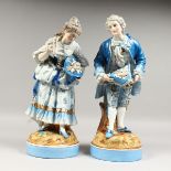 A GOOD PAIR OF FRENCH AUGUSTUS REX STYLE GALLANT AND LADY in colourful garb, on circular bases.