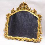 A GILT OVERMANTLE MIRROR with domed glass and pierced frame. 3 ft. high, 3 ft 7 in. wide.