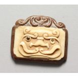 A JAPANESE CARVED WOOD AND BONE PENDANT 2.25 ins