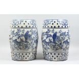 A PAIR OF CHINESE BLUE AND WHITE BARREL SEATS with birch and flowers 17 ins high